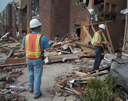 image of SAVE volunteers inspect a building damaged by the EF-5 tornado that struck Joplin on May 22, 2011. 